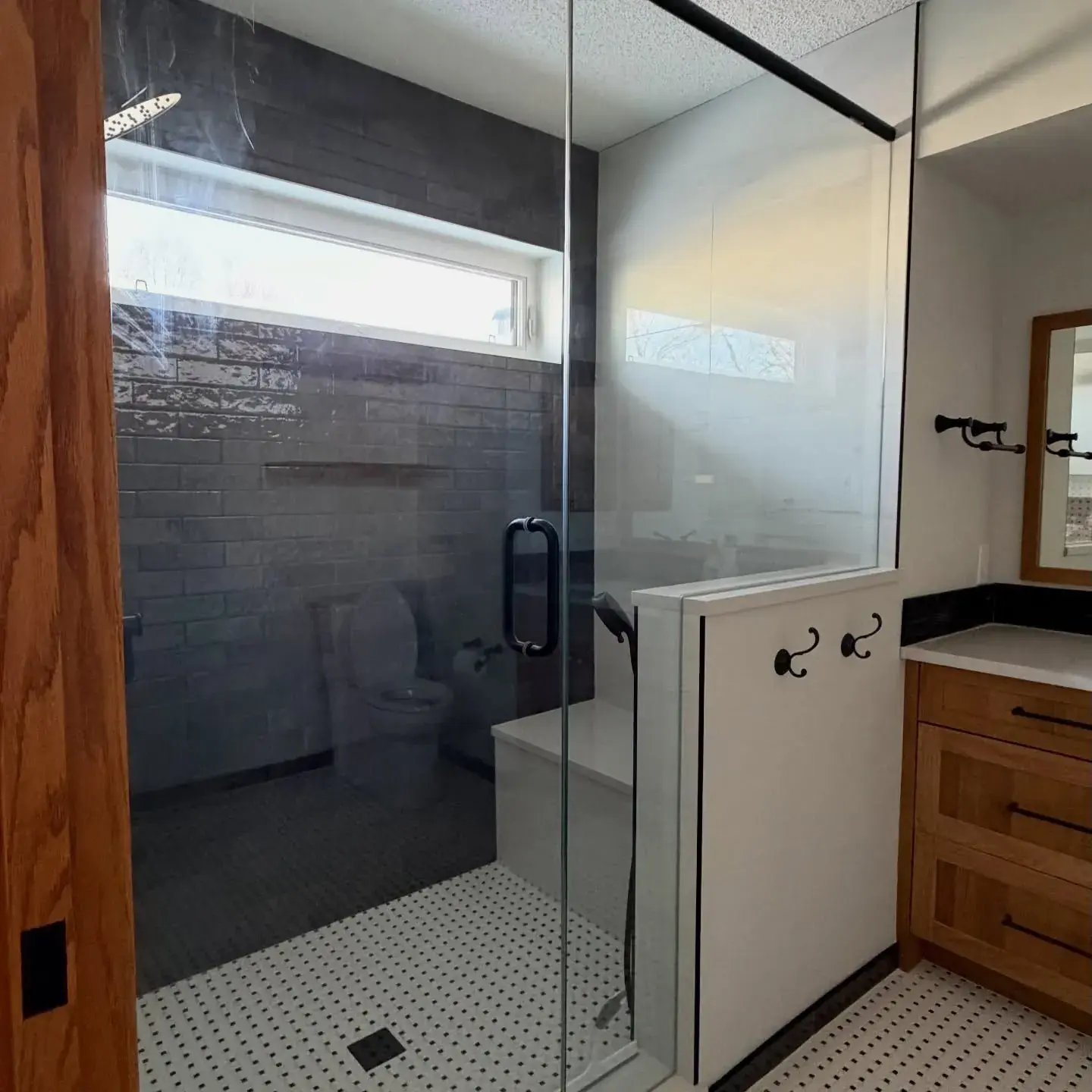Modern Tile Bathroom — Crisp walls and trim around a sleek glass-and-tile shower