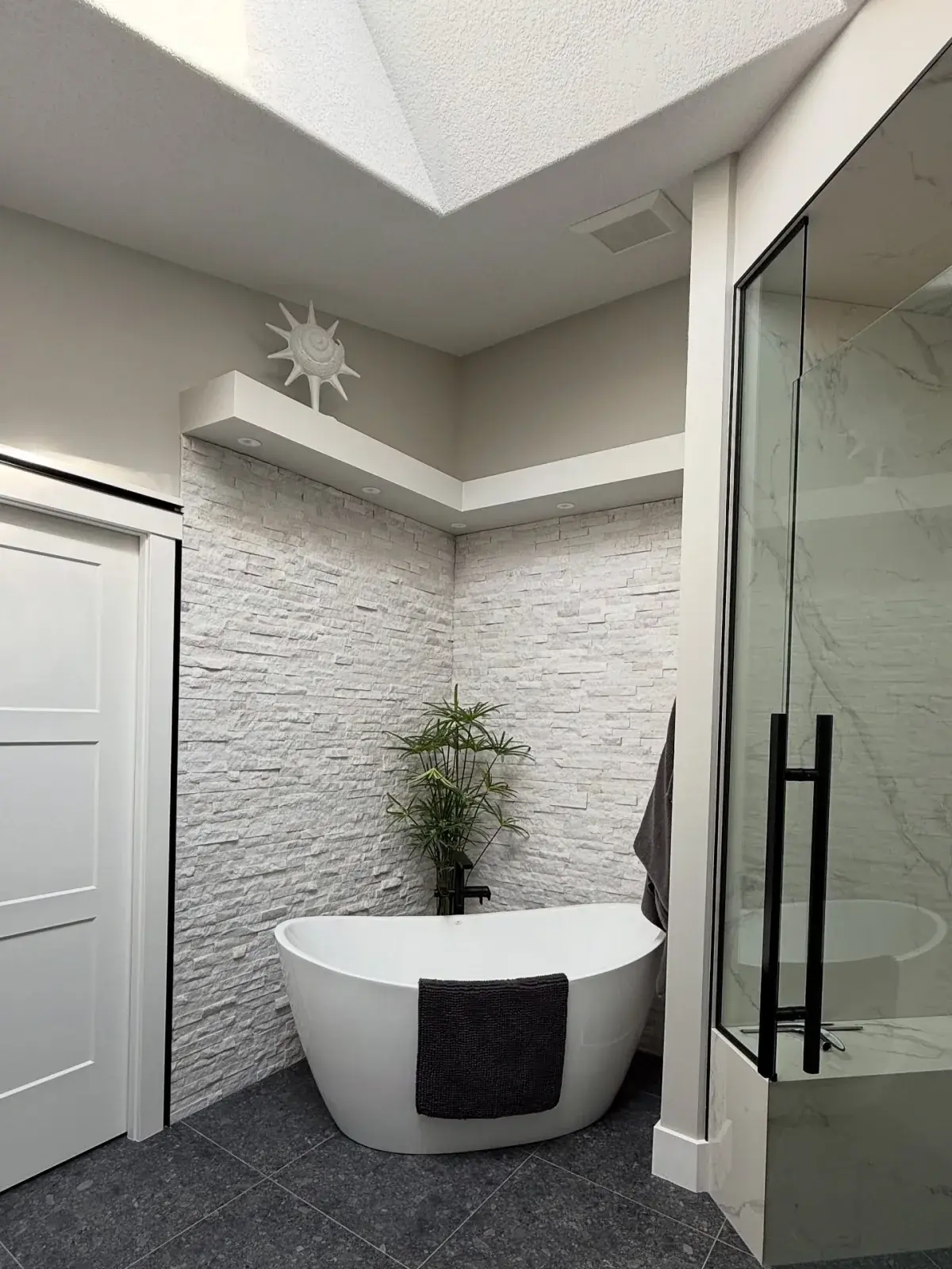 Spa-Style Ensuite Repaint — A bright ensuite with a freestanding tub and stone feature wall