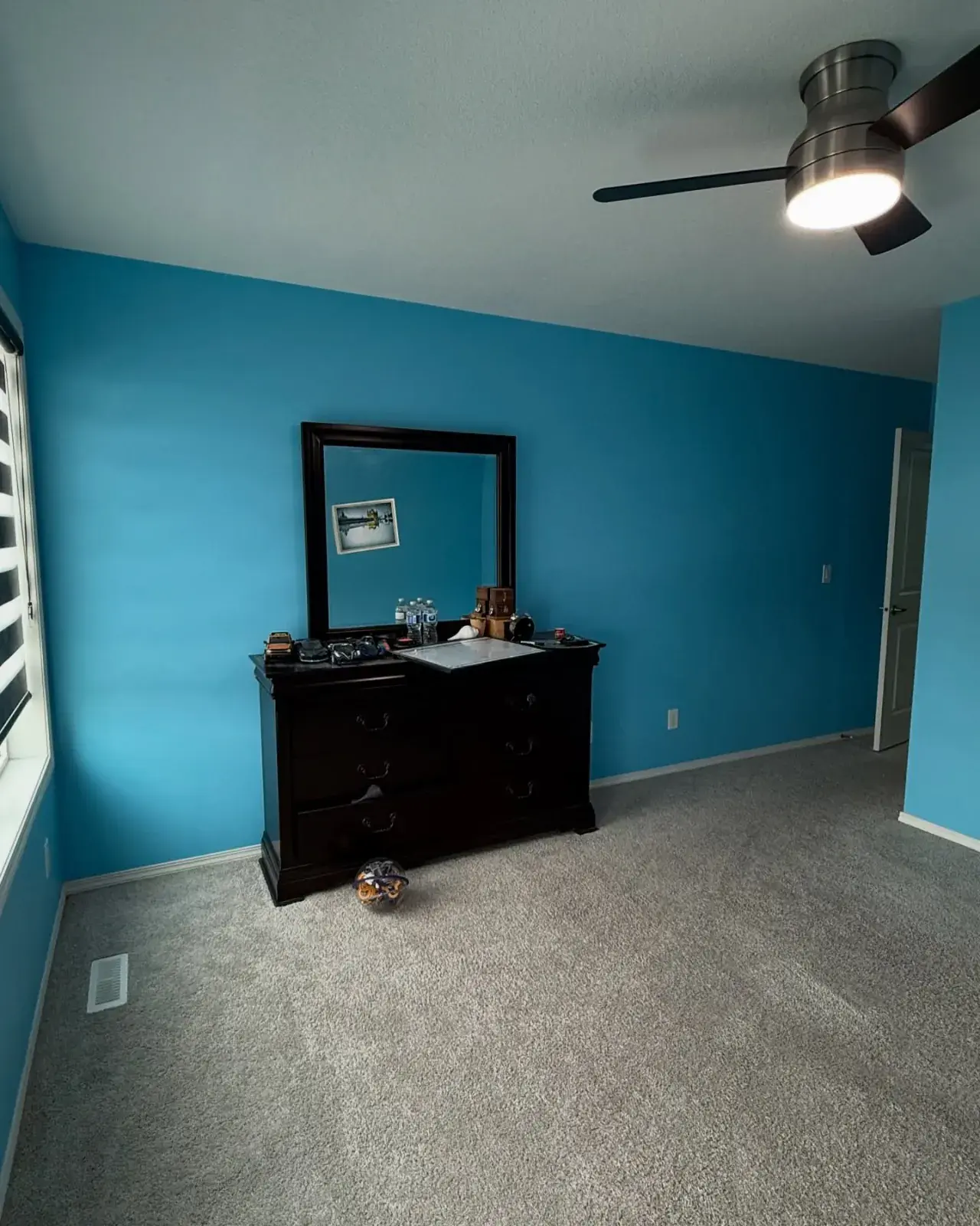 Teal Accent Bedroom — A bold teal feature wall with clean, even coverage