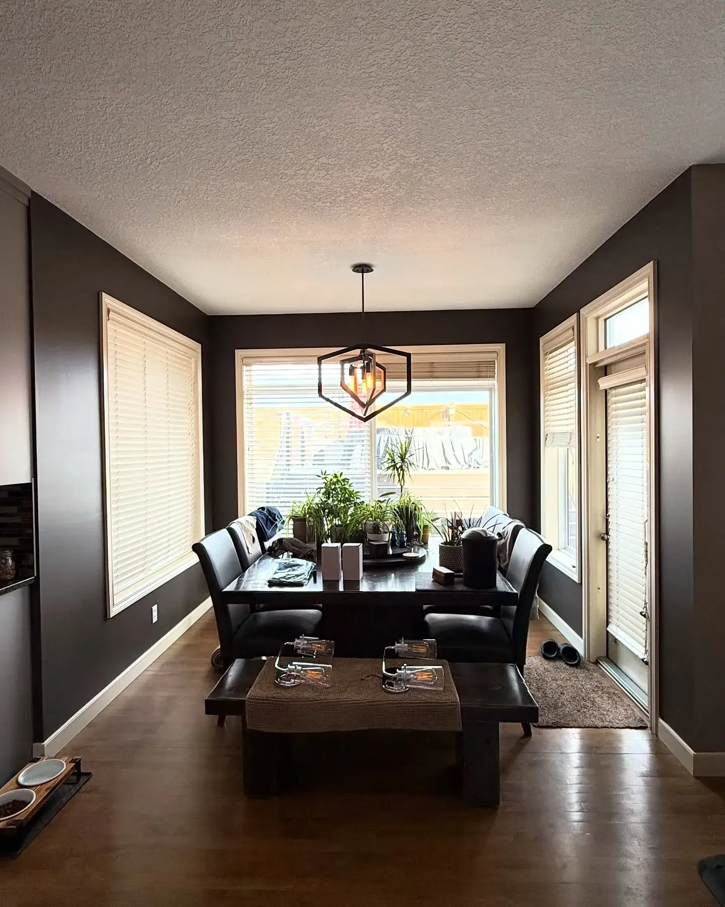 Moody Charcoal Dining Room — Deep charcoal walls with clean white trim for a cozy, modern dining space