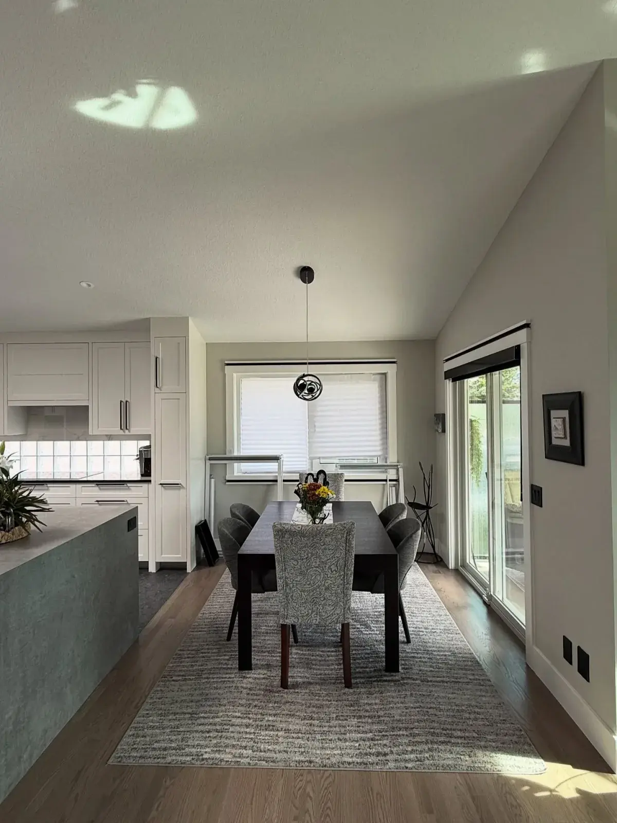 Vaulted Dining & Kitchen Repaint — Bright open-concept dining and kitchen finished wall to wall