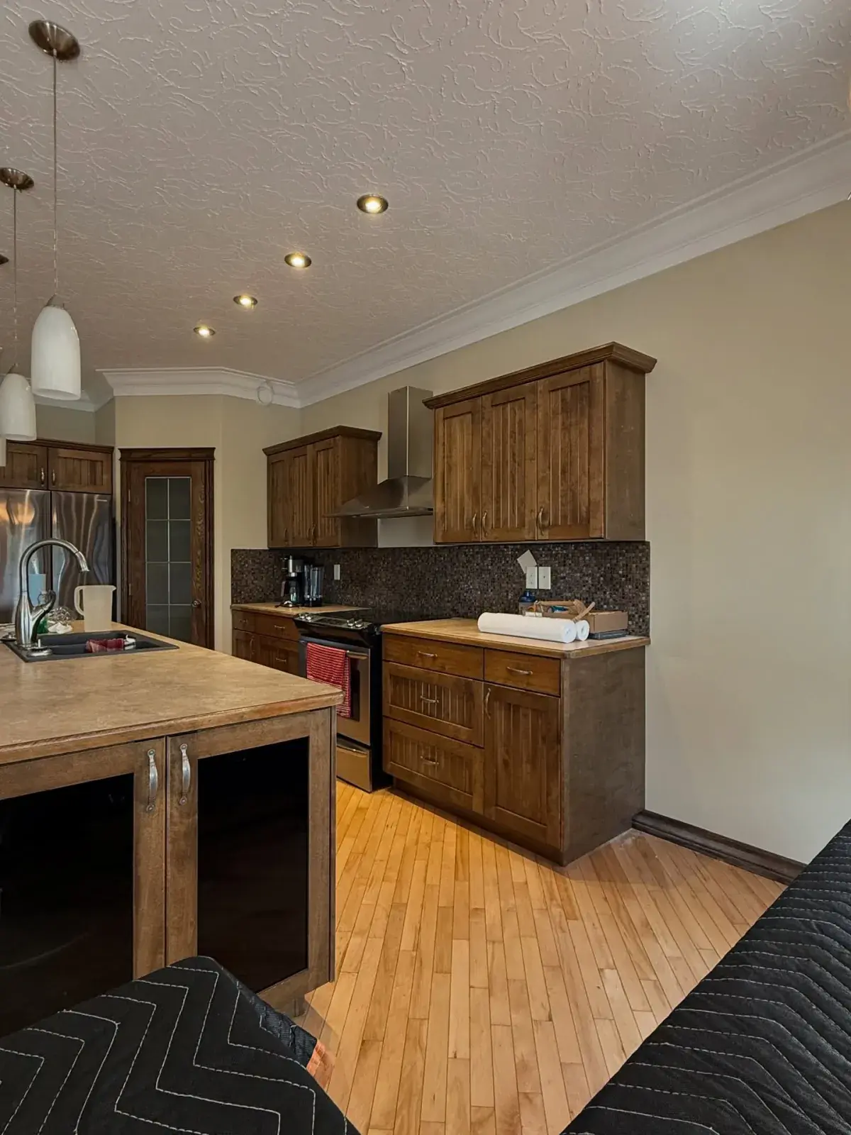 Warm Wood Kitchen — Solid wood cabinets refreshed with a clean, even finish