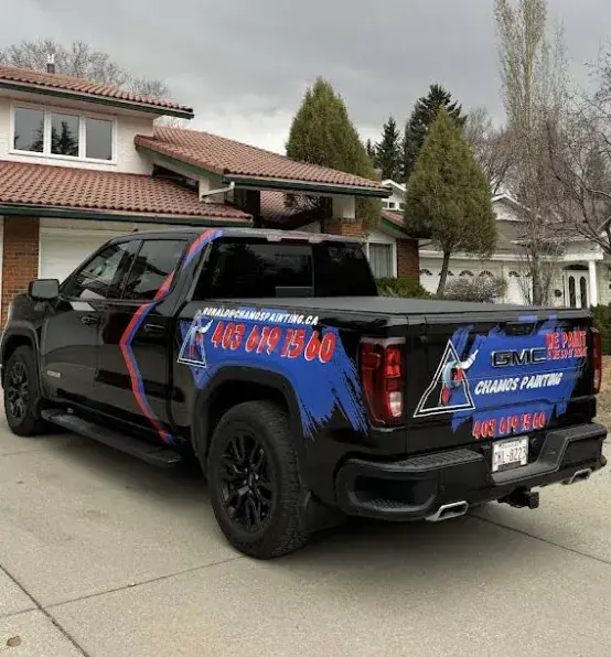 The branded Chamos Painting truck parked in a Calgary residential driveway