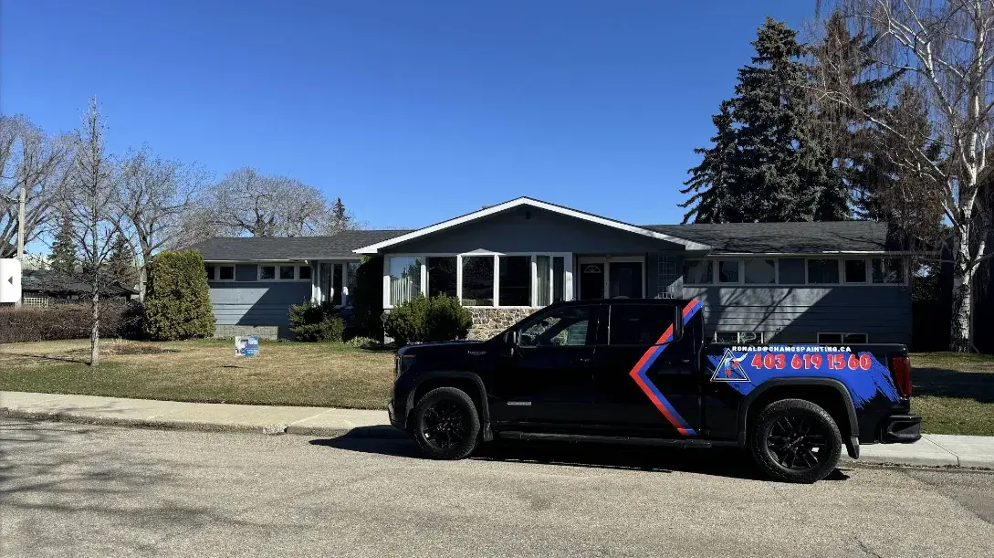 The Chamos Painting branded truck outside a freshly painted Calgary home after an exterior painting project