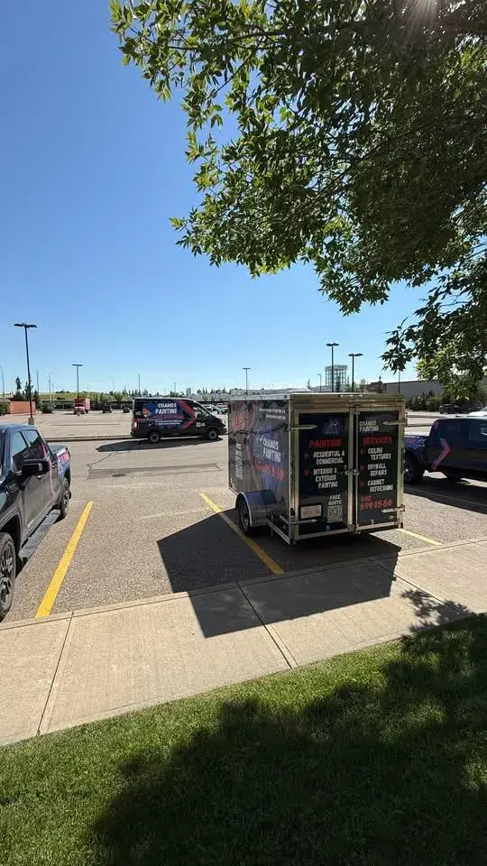 The Chamos Painting services trailer parked and ready outside a Calgary home for an interior painting project
